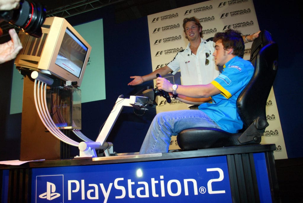 Fernando Alonso and Jenson Button have fun on a simulator for a Sony Playstation 2 Event © XPB Images
