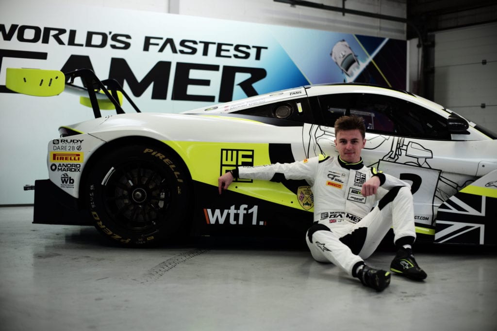 James Baldwin, the esports racer who won the “World's Fastest Gamer” competition, pictured with the WTF1 Logo. Photo: Evian Varu © WTF1
