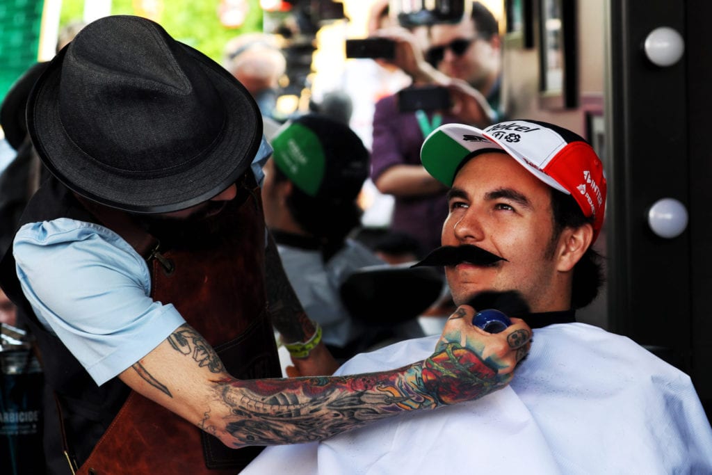 Sergio Perez visits the paddock barbers for the Movember Foundation charity © XPB Images